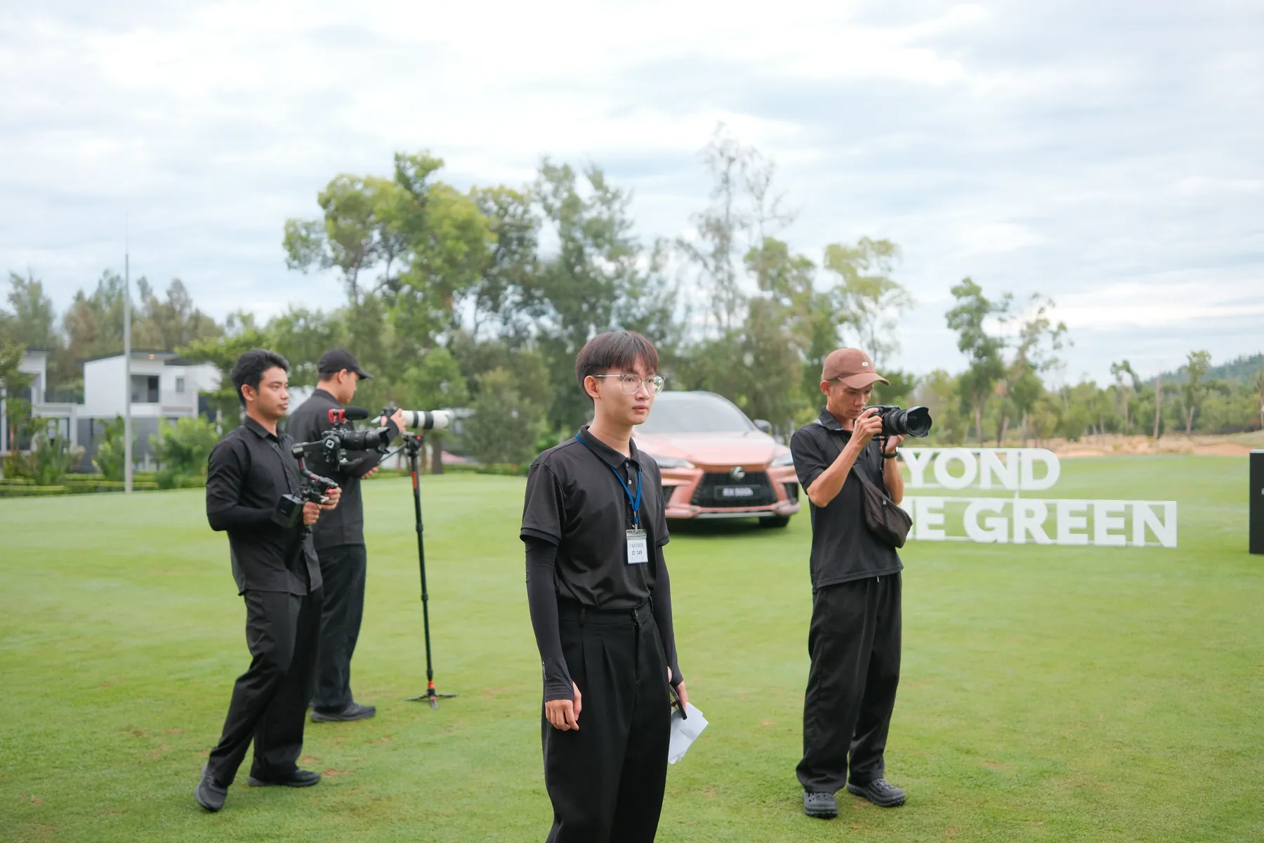 Crew set up beside the Lexus RX 500h on the green