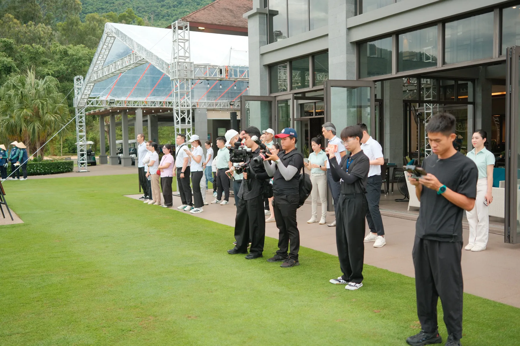 Full crew and guests lined up along the clubhouse lawn