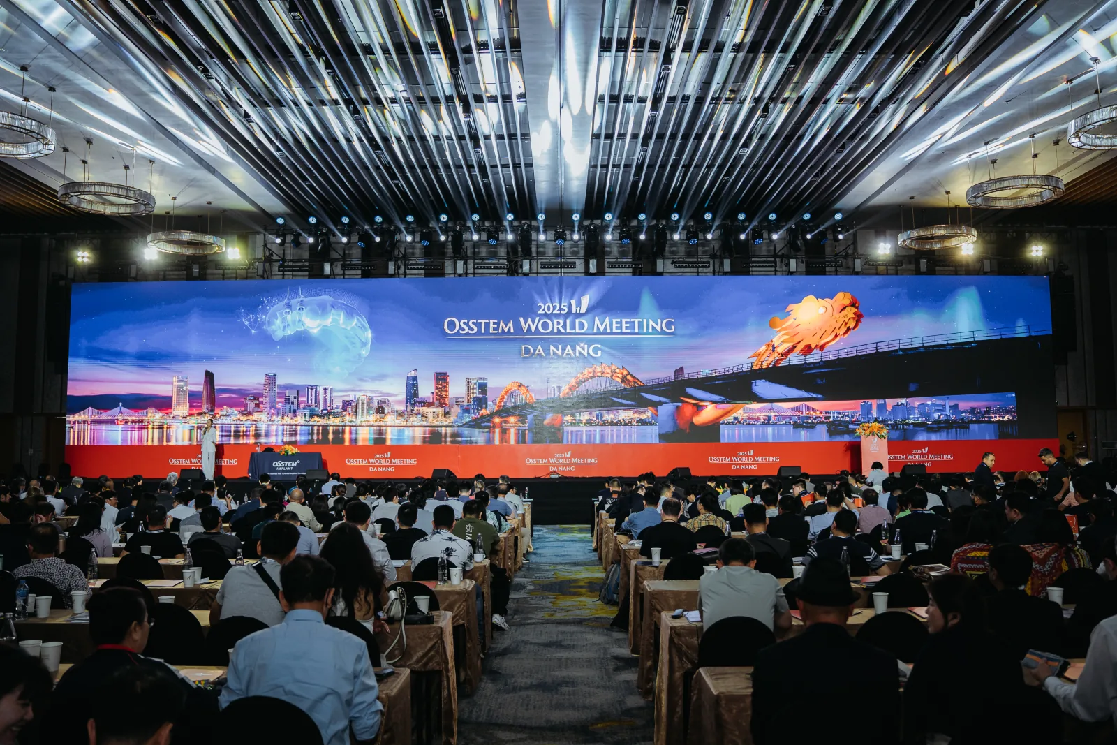 The 2025 Osstem World Meeting key visual across the main hall LED wall in Da Nang
